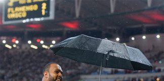 Alecsandro com guada-chuva em temporal no Maracanã