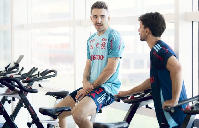 Léo Ortiz conversa com Rodrigo Caio enquanto faz bicicleta no Ninho do Urubu